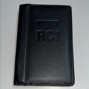 RCI black leather passport holder. 4 1/4”L X 5 1/2” H.